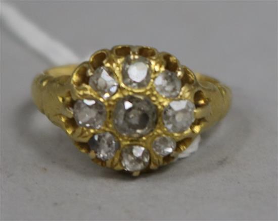 An early 20th century 18ct gold and old mine cut diamond cluster ring, size J.